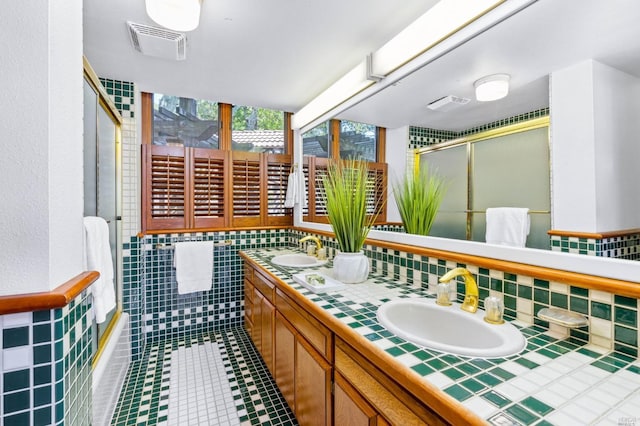 bathroom with backsplash, tile walls, tile floors, dual sinks, and large vanity