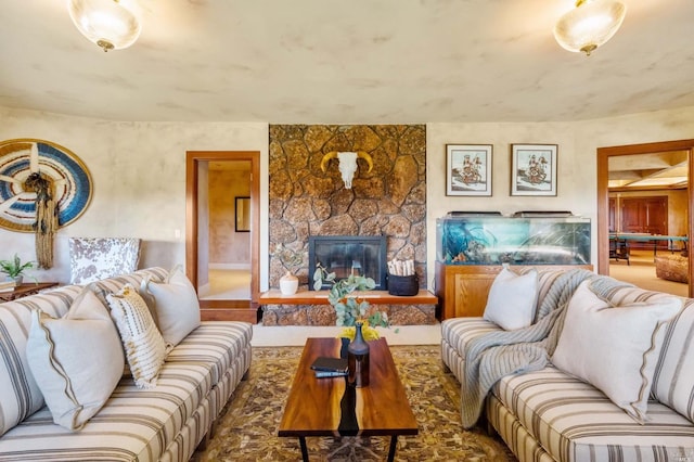 living room featuring a stone fireplace