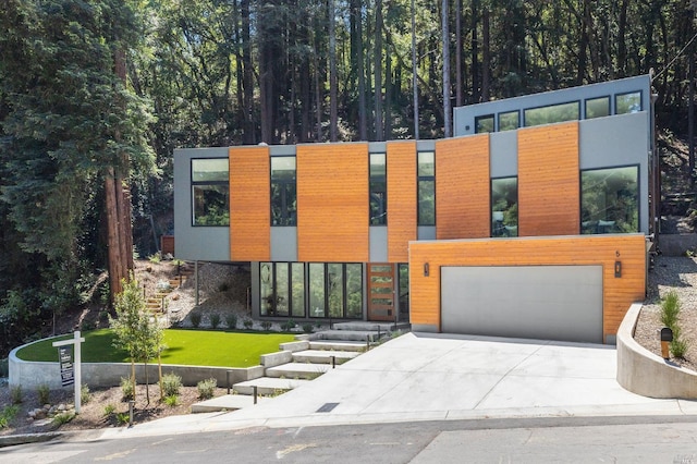 modern home featuring a front yard and a garage