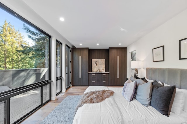 bedroom featuring multiple windows and light wood-type flooring