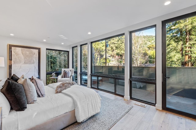 bedroom featuring light hardwood / wood-style floors and access to outside