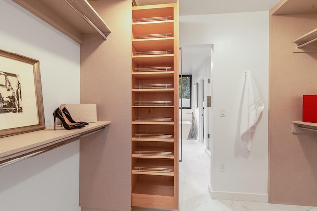 walk in closet featuring light tile flooring