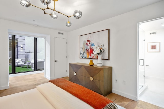 bedroom featuring a notable chandelier and light hardwood / wood-style flooring