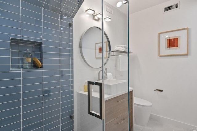 bathroom with vanity, tile flooring, and toilet