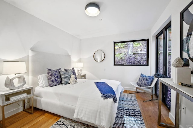 bedroom with hardwood / wood-style floors