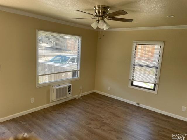 unfurnished room featuring a wall mounted air conditioner, crown molding, ceiling fan, and dark wood-type flooring