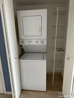 laundry area featuring stacked washer / dryer