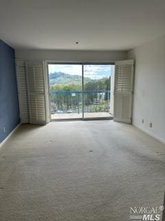 unfurnished room featuring light colored carpet