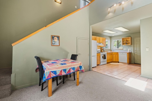 rec room with sink, rail lighting, and light tile flooring