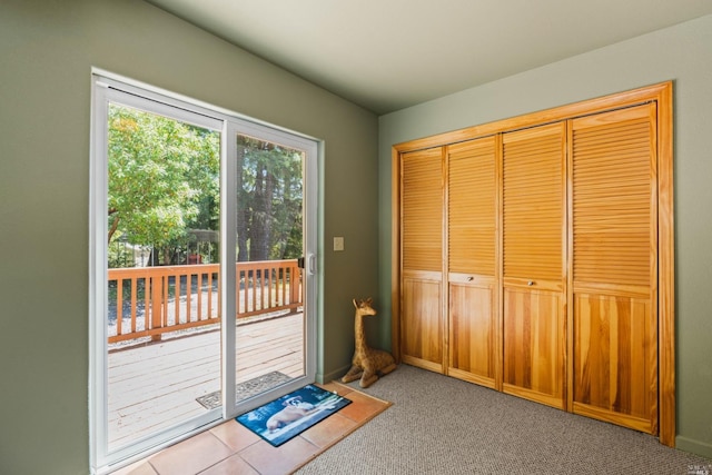 doorway to outside featuring light carpet