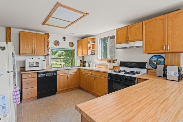 kitchen featuring light tile flooring, plenty of natural light, white appliances, and sink