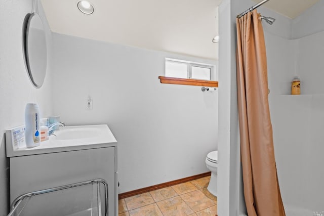 bathroom featuring tile flooring, large vanity, and toilet