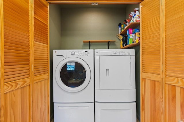 clothes washing area featuring washer and clothes dryer