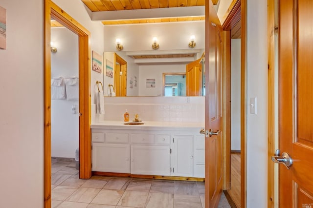 bathroom featuring oversized vanity, wooden ceiling, and tile flooring