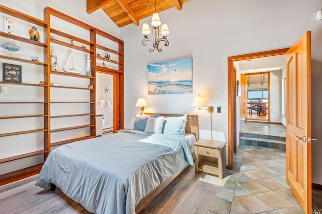 bedroom featuring wooden ceiling, a notable chandelier, lofted ceiling with beams, and light tile floors