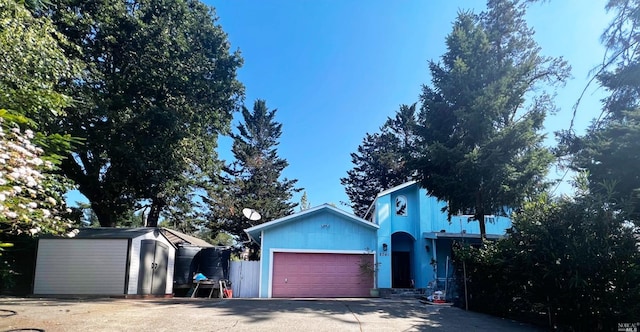 view of front of house featuring a storage unit and a garage