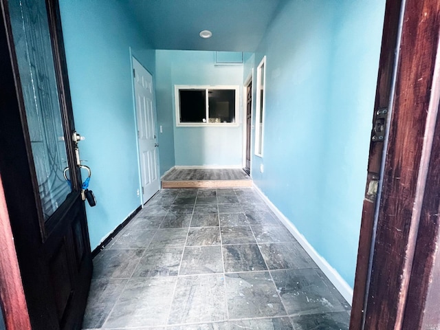 hall featuring dark tile floors