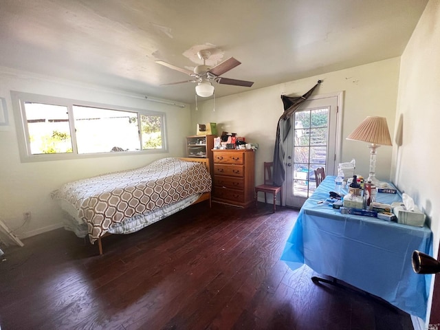 bedroom with dark hardwood / wood-style floors, ceiling fan, and multiple windows