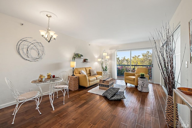 living room with a notable chandelier and dark wood-type flooring