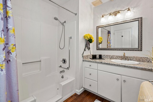 bathroom featuring shower / bath combo with shower curtain, vanity, and hardwood / wood-style flooring