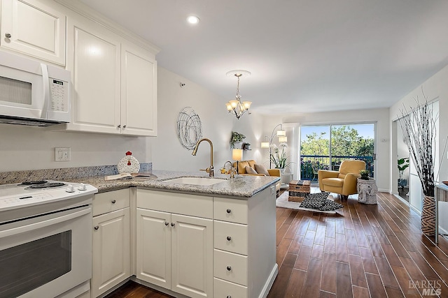 kitchen featuring dark wood-type flooring, light stone counters, white appliances, sink, and white cabinetry