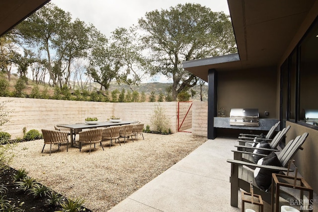 view of patio / terrace featuring a fenced backyard, a grill, and outdoor dining space