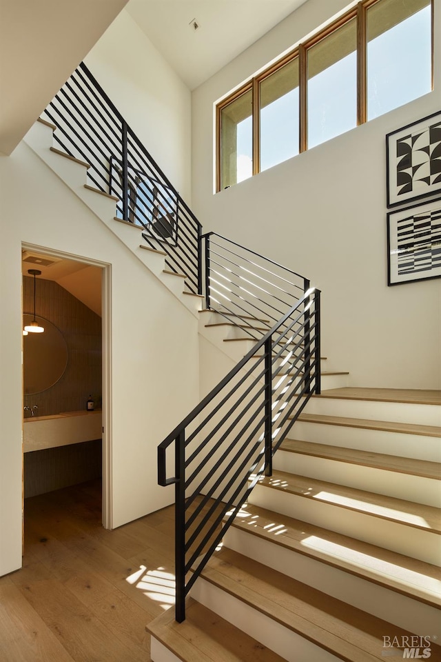 stairs featuring wood finished floors