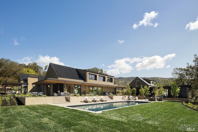 pool with a yard and a patio