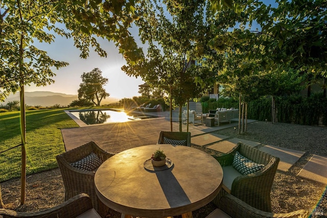 view of patio / terrace featuring outdoor dining area, a water view, and outdoor lounge area