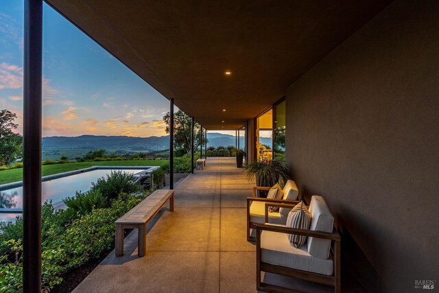 view of patio with a balcony and a mountain view