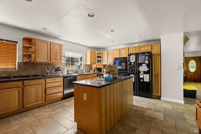 kitchen featuring backsplash, light tile floors, black appliances, and a kitchen island with sink