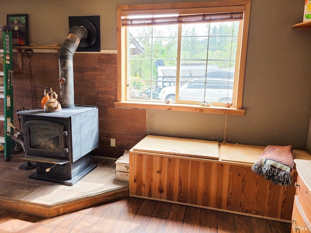 room details featuring hardwood / wood-style floors and a wood stove