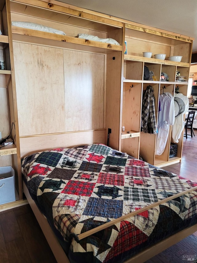 bedroom with dark wood-type flooring