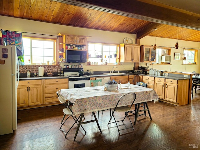 kitchen featuring beam ceiling, white appliances, pendant lighting, and a healthy amount of sunlight