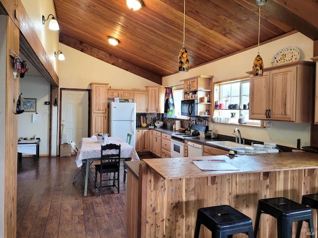 kitchen with sink, dark hardwood / wood-style floors, kitchen peninsula, white appliances, and a breakfast bar