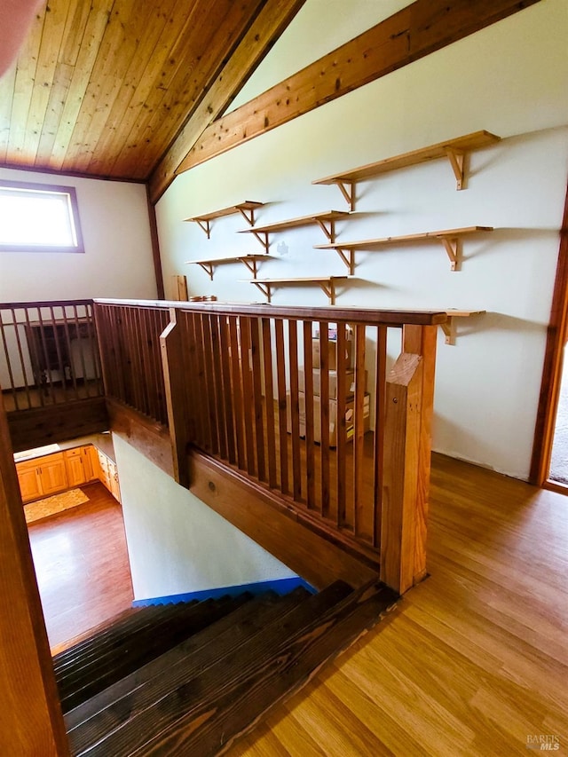 hall featuring wood-type flooring, lofted ceiling, and wood ceiling