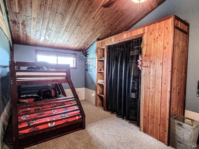 bedroom featuring carpet flooring, lofted ceiling, and wood ceiling