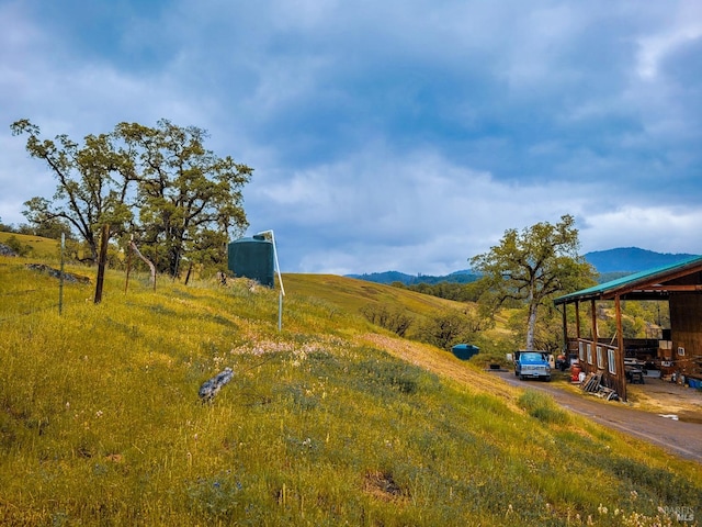 view of yard featuring a mountain view and a rural view