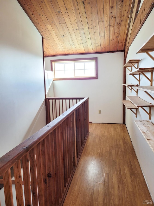 corridor with hardwood / wood-style floors and wooden ceiling