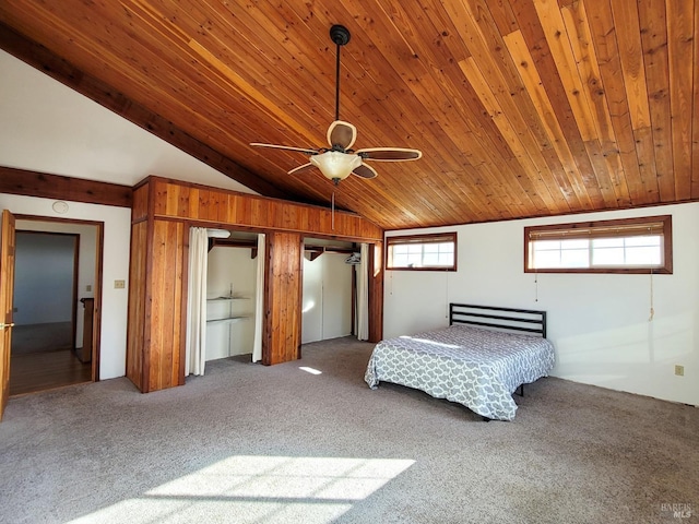 unfurnished bedroom featuring carpet flooring, ceiling fan, wooden ceiling, and lofted ceiling