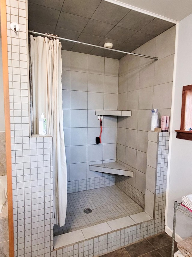 bathroom with tile patterned floors and a shower with curtain