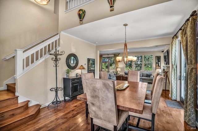 dining space with a chandelier, crown molding, and dark wood-type flooring