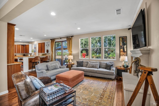 living room featuring ornamental molding and dark hardwood / wood-style floors