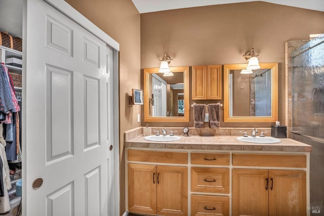 bathroom with dual vanity and vaulted ceiling