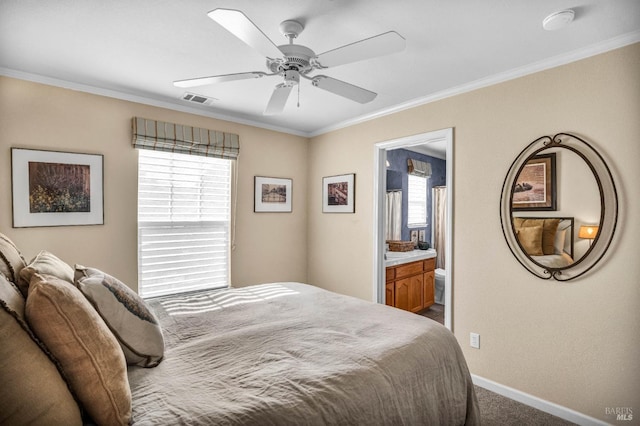 bedroom featuring carpet, multiple windows, ensuite bath, and ceiling fan