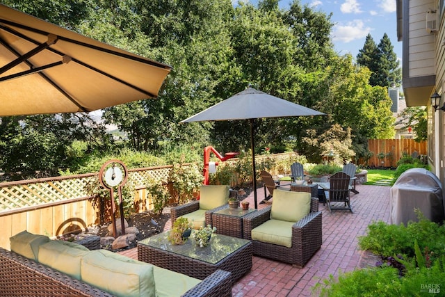 view of patio / terrace featuring an outdoor living space with a fire pit