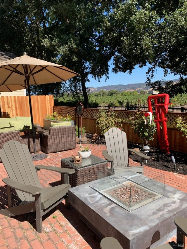 wooden deck featuring an outdoor living space with a fire pit and a patio