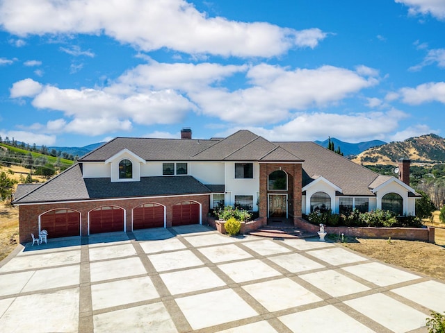 view of front of property featuring a mountain view and a garage