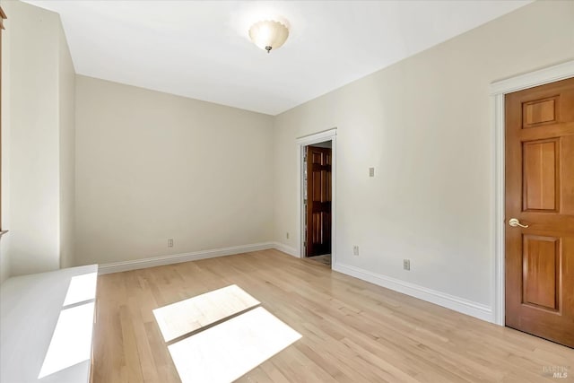 spare room with light hardwood / wood-style flooring