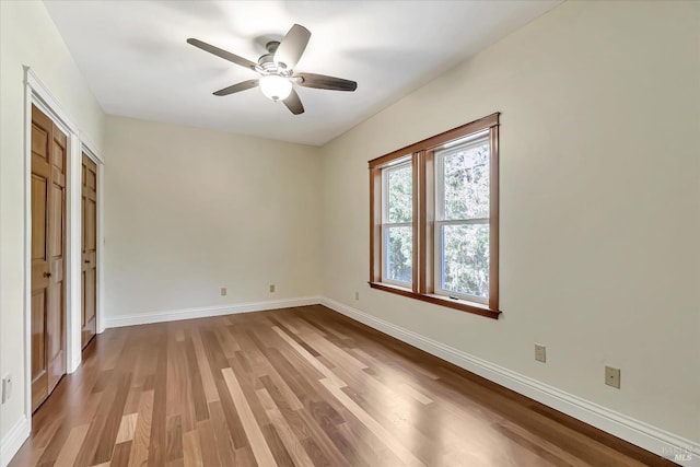 unfurnished bedroom featuring hardwood / wood-style flooring and ceiling fan